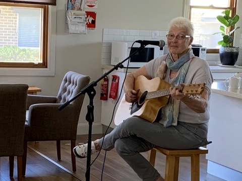 Riverside Gardens Resident playing the guitar